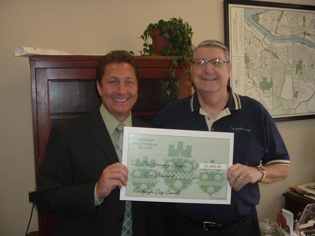 Councilman Jeff Koch (left) presents the Harmony Singers with a grant from the City of Pittsburgh (2007).