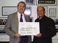 Councilman Jim Motznik (right) presents the Harmony Singers with a grant from the City of Pittsburgh (2003).